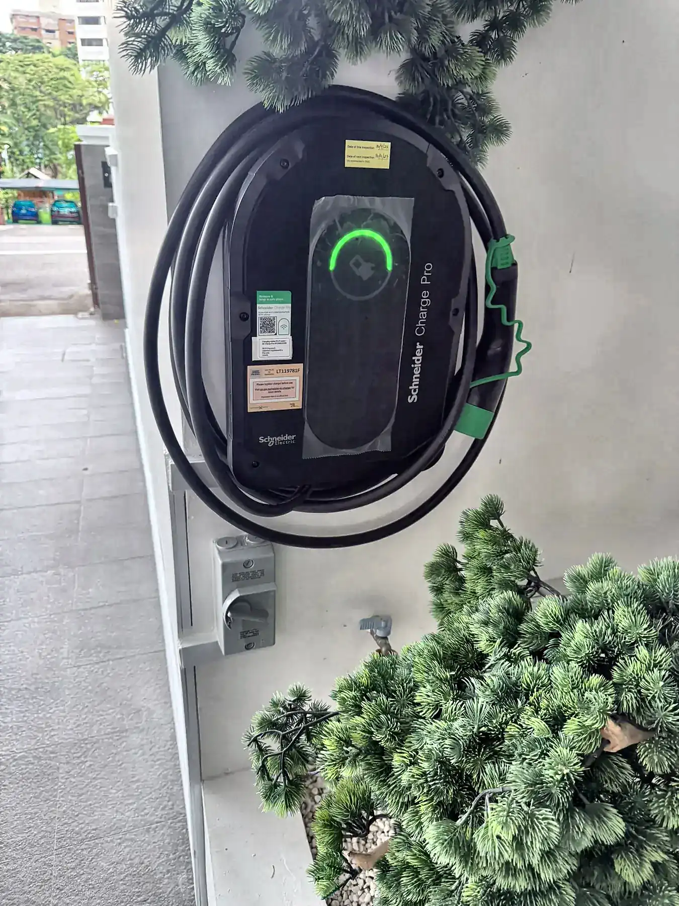 Schneider Charge 22 kW three-phase EV charger installed outdoors with isolators mounted below.