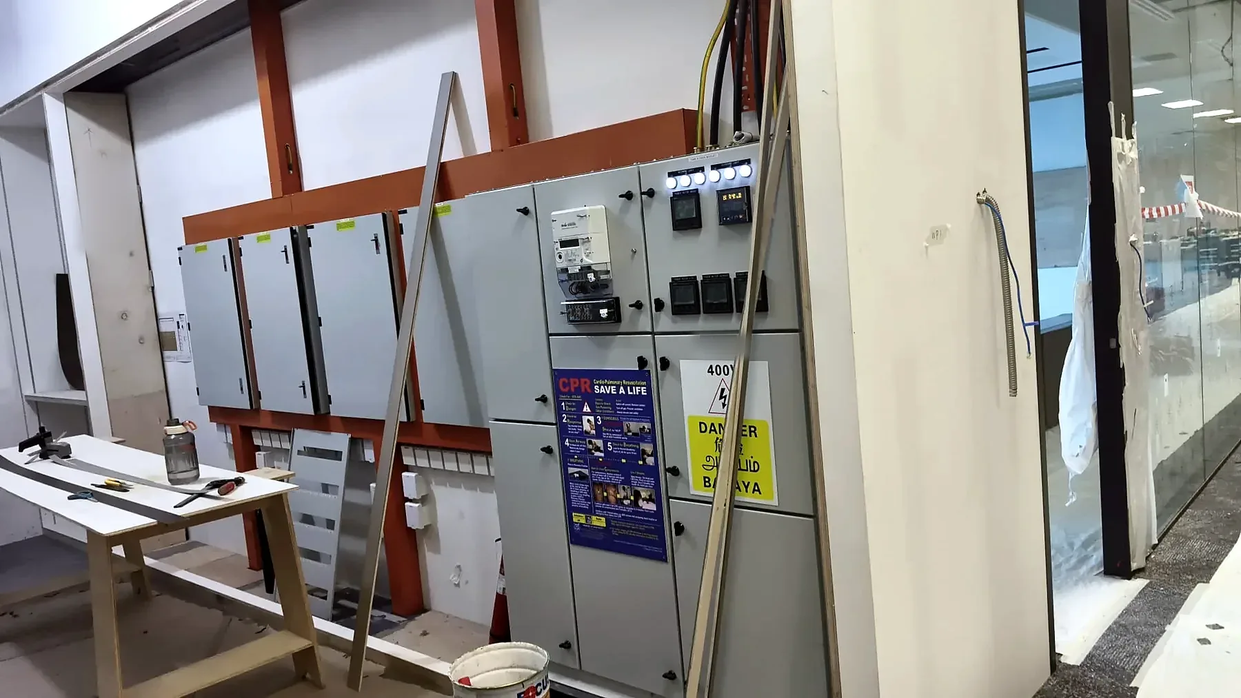 Switchboard installation with 400V danger labelling and safety signage during second fix.